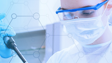 Laboratory professional wearing PPE pipetting samples in a lab